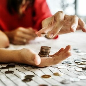 A hand holding a stack of pennies