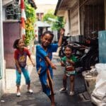 children playing in a city alley way