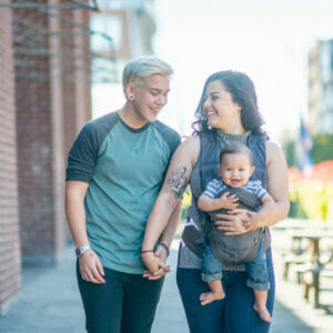 LGBTQ couple holding their baby