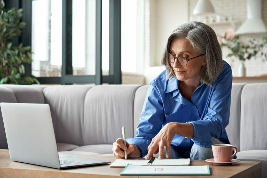 Woman taking notes on a laptop