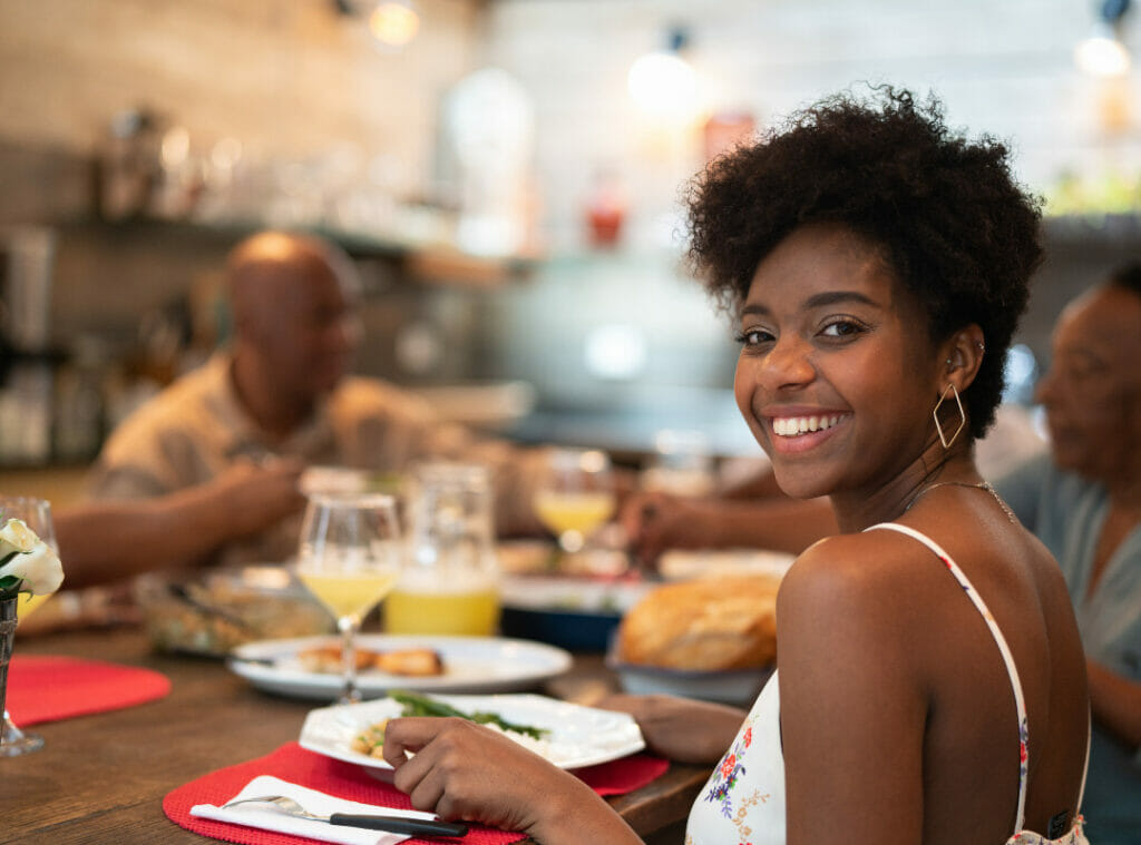 Smiling woman at a restaurant table.