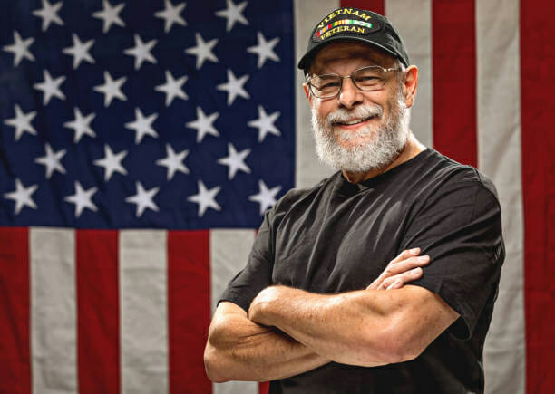 Veteran posed in front of American flag