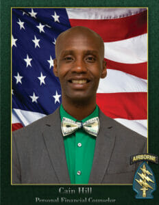 Cain smiling in front of the American flag wearing a suit and a $100 bow tie