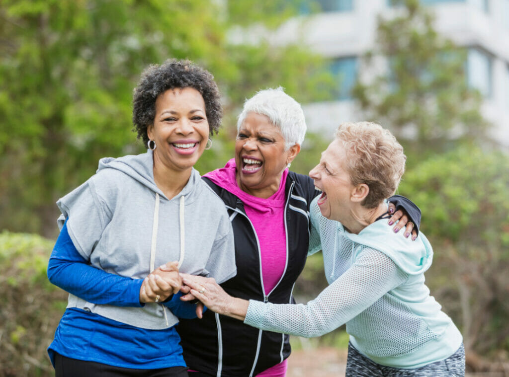 Three older women spending time together on a jog