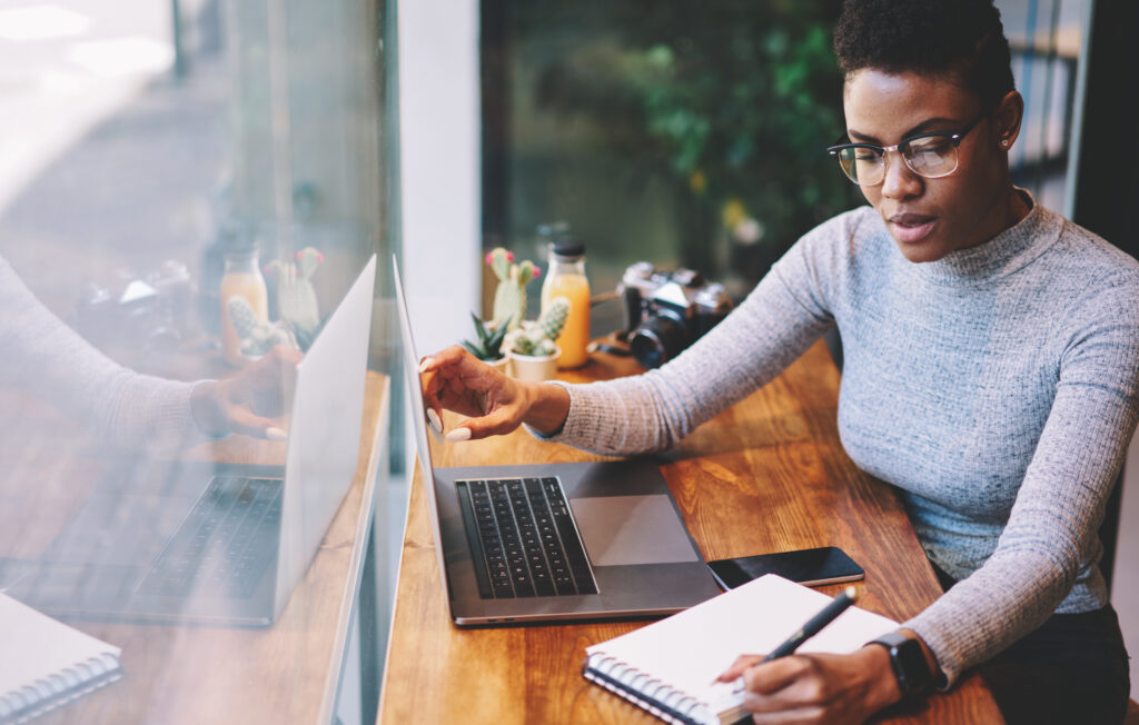 Black Woman working on the computer in her home