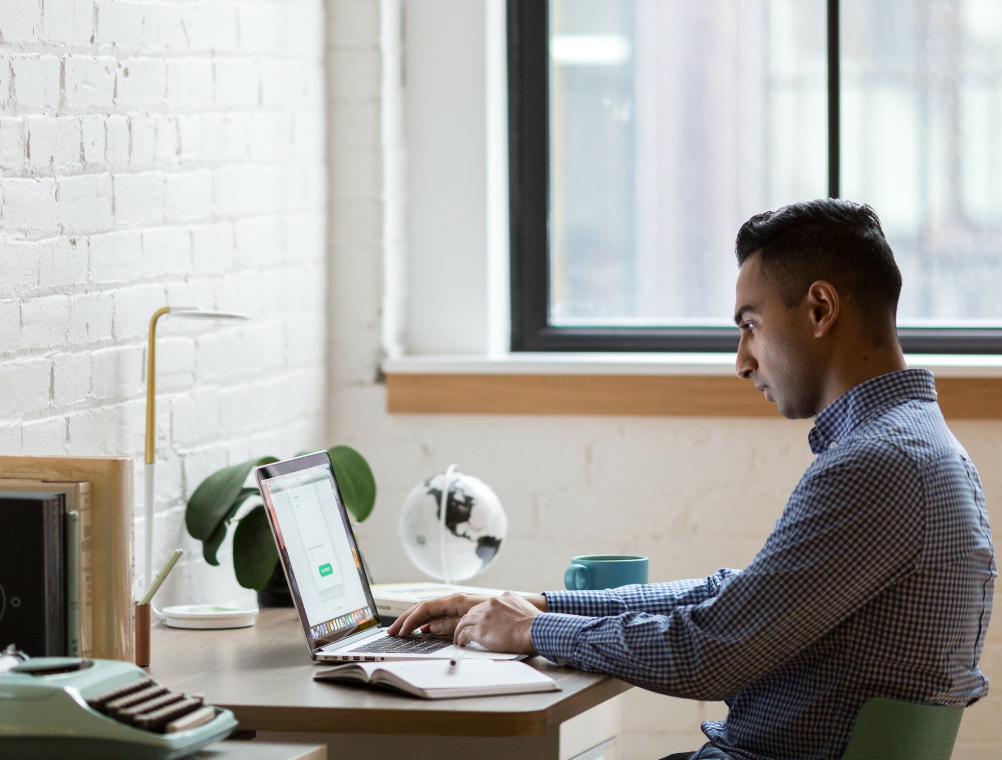 Man sitting in home office on computer.