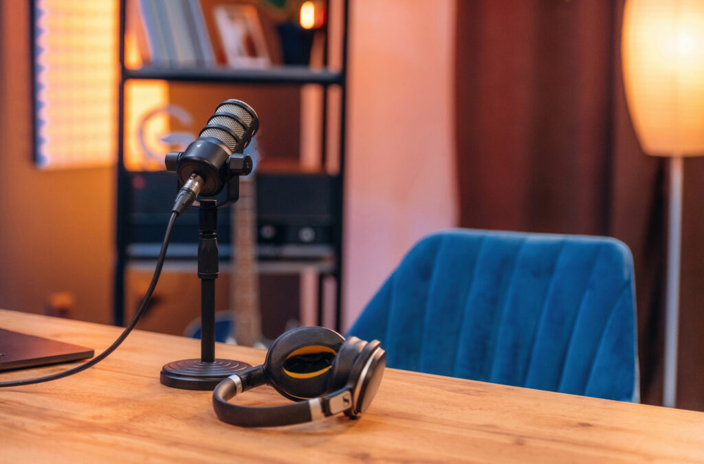 Microphone and headphones are on the table, room for podcasts