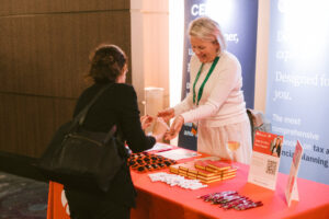 Exhibitor having a conversation with a Symposium attendee