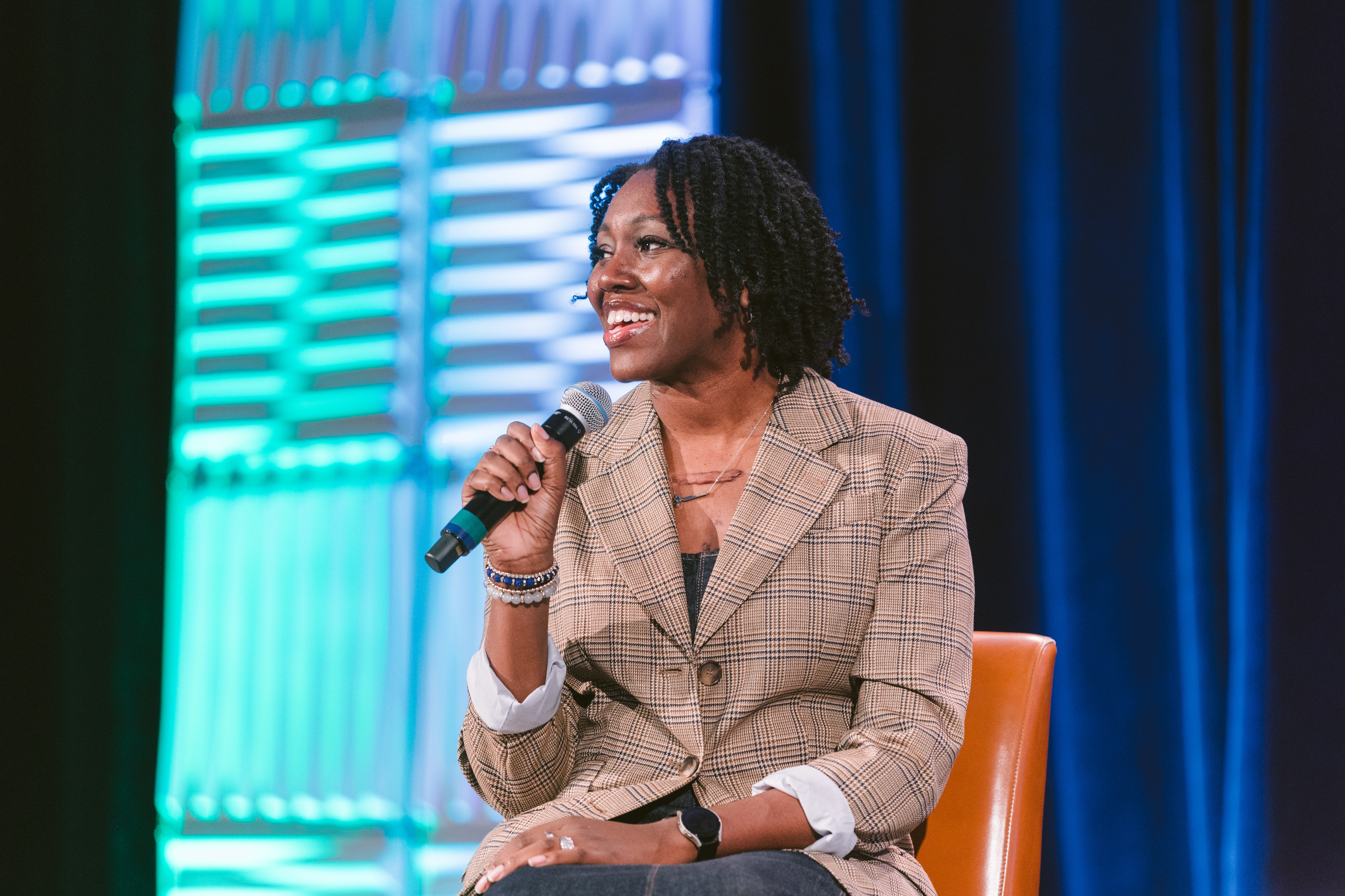 Former Board President Brandy Baxter on stage at Symposium