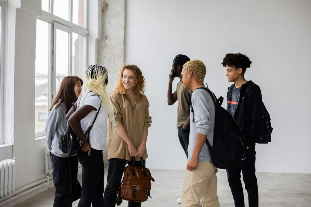 Diverse group of students talking in a white room
