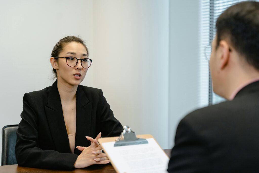 woman of asian descent in the middle of a job interview with a man