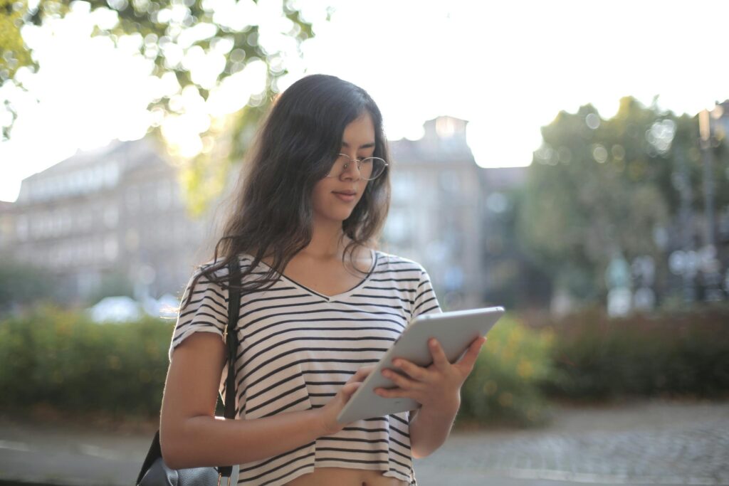 Young woman reading on her tablet