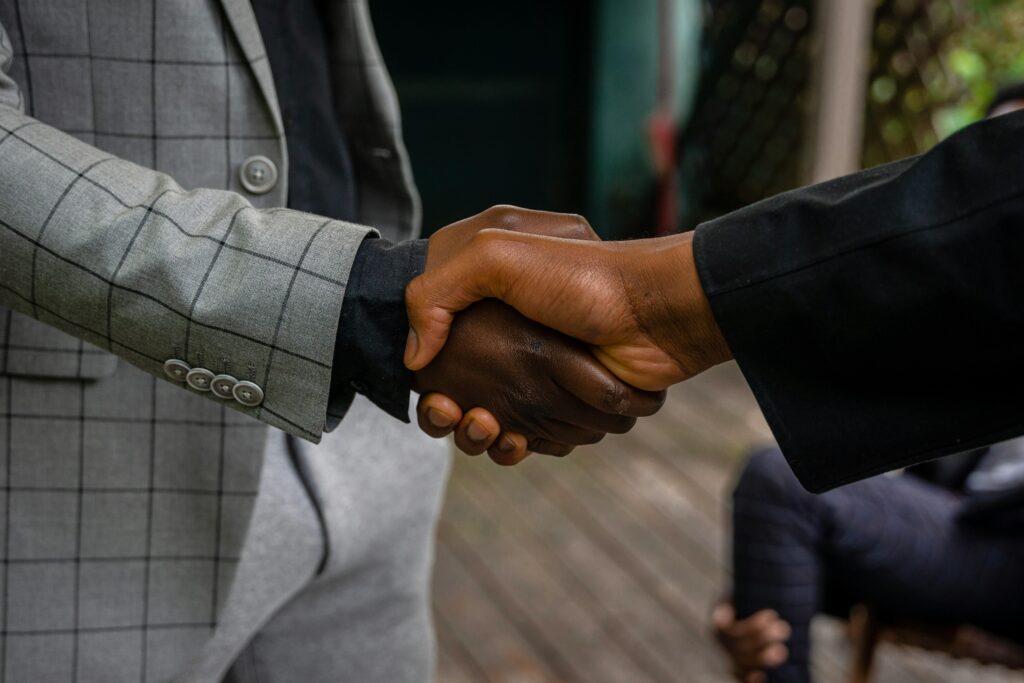 two men of color shaking hands