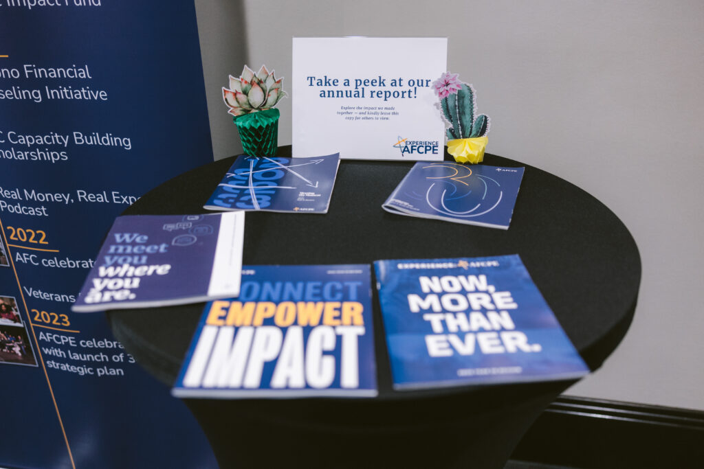 a handful of blue AFCPE brochures on a table