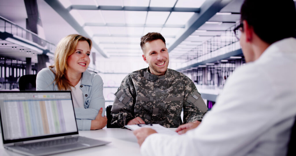 Military couple talking to a financial professional.