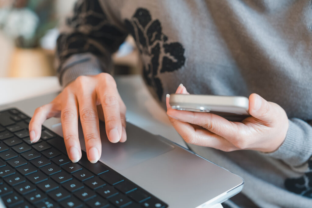 Closeup of hands typing on a laptop keyboard, representing a writer preparing documents, writing articles, or working on reports in a modern office or remote workspace