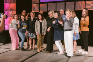 Diverse group of people on stage at Symposium