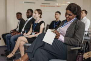 professional black woman taking notes in a diverse classroom