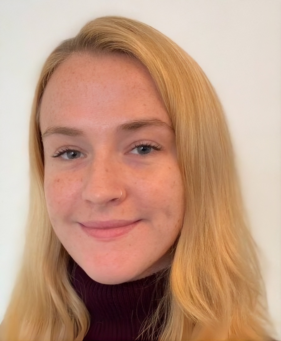 headshot of a white woman with a coy smile with long blonde hair