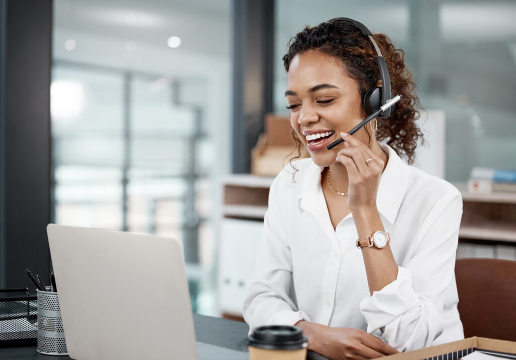 Cropped shot of a young black female call center agent working at her desk in the office