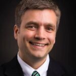 Man smiling in a headshot.