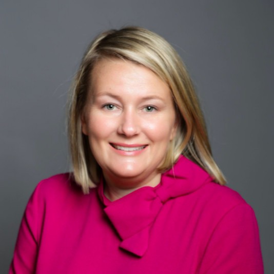 Photo of a woman smiling in a headshot.