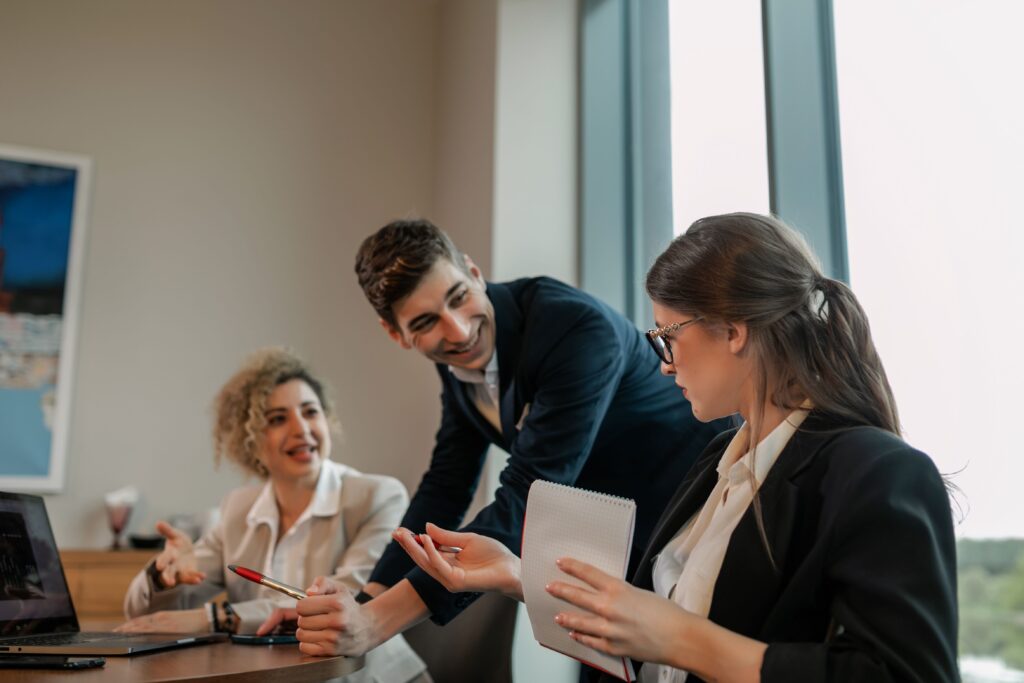 Small group of diverse business professionals reviewing work during a meeting