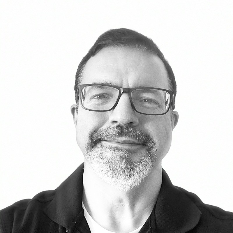 Headshot of a man wearing a black shirt. 