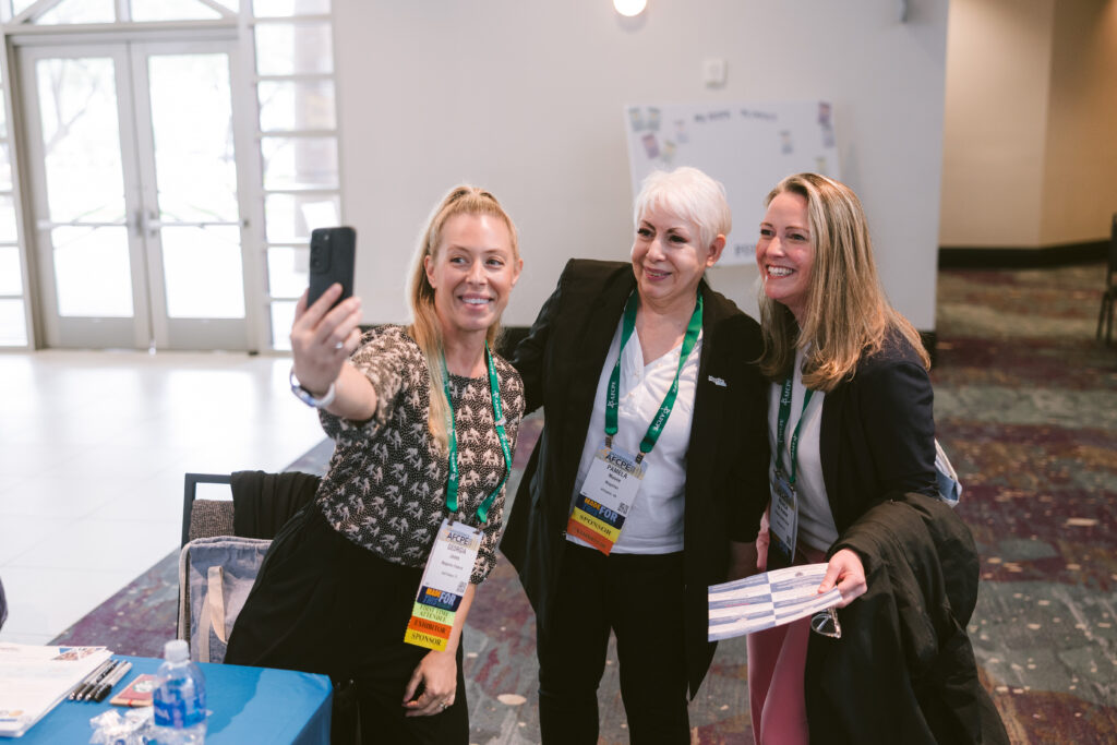 three white women taking a selfie and smiling