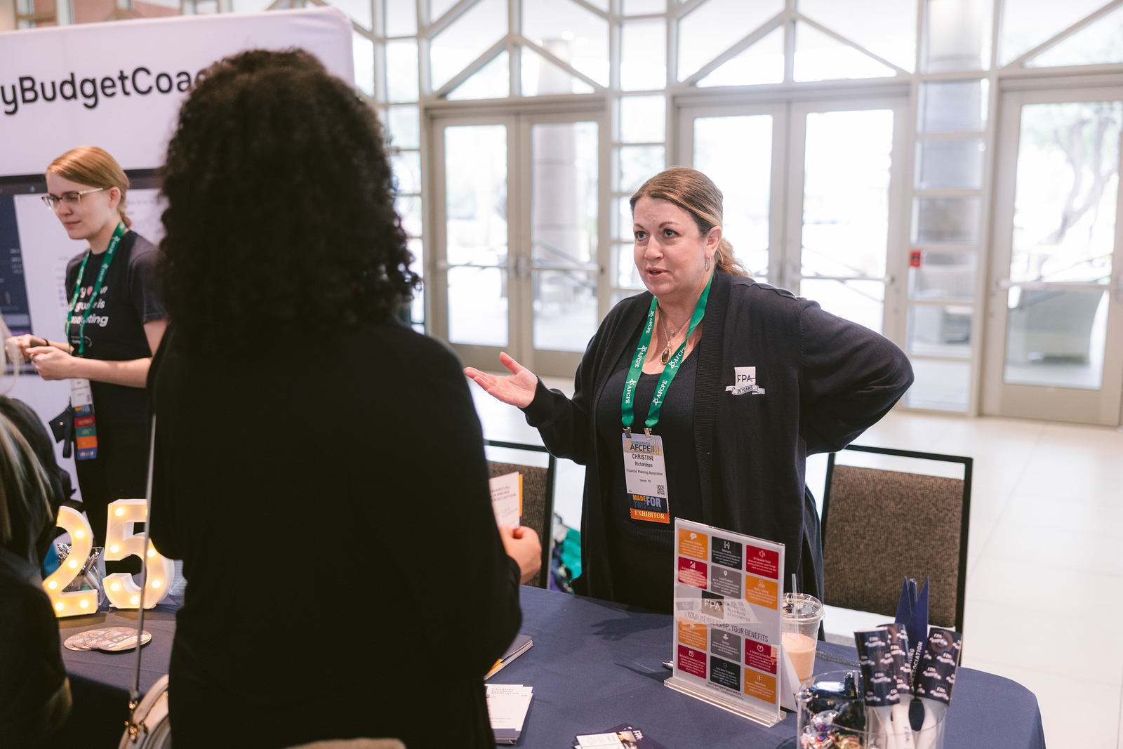 Two women talking to each other at AFCPE Symposium.
