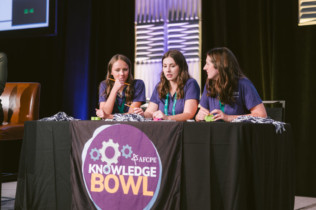 Photo of three students from Kansas State University participating at Knowledge Bowl 2025 Symposium.