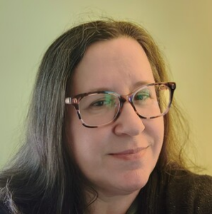 Headshot of a woman with glasses.
