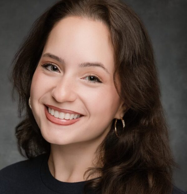 white woman smiling with long brown hair